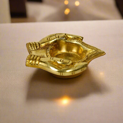 Image of a brass Bhakti Diya, beautifully handcrafted with intricate detailing. The diya features a traditional design with a sturdy base and a deep bowl for holding oil or ghee. Its polished brass finish enhances its aesthetic appeal, making it ideal for spiritual rituals, home décor, or gifting during festive occasions.