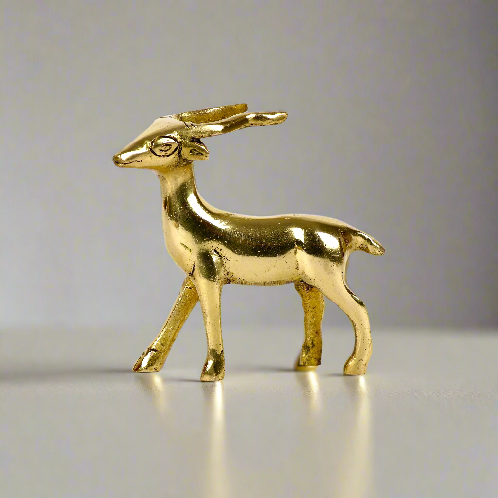 Image of a brass deer statue, elegantly designed with intricate detailing. The deer is depicted in a graceful standing posture, symbolizing peace, harmony, and gentleness. Crafted from polished brass, this statue is ideal for Vastu, home décor, or gifting to enhance positive energy and elegance in any space.