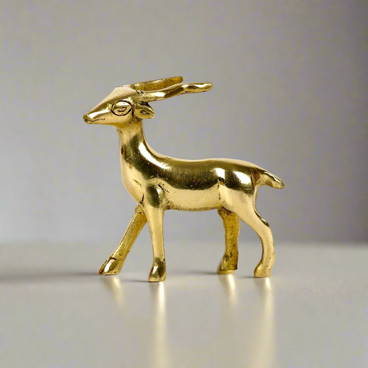 Image of a brass deer statue, elegantly designed with intricate detailing. The deer is depicted in a graceful standing posture, symbolizing peace, harmony, and gentleness. Crafted from polished brass, this statue is ideal for Vastu, home décor, or gifting to enhance positive energy and elegance in any space.