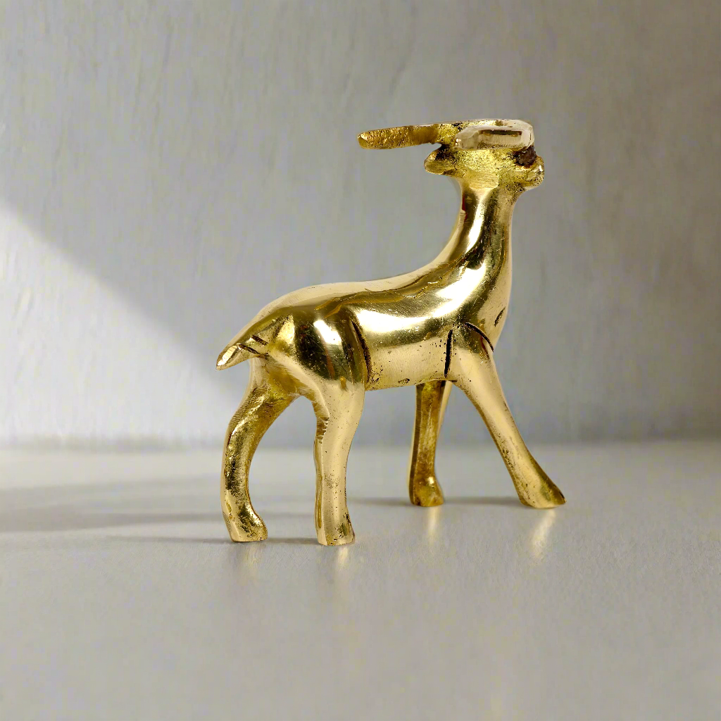 Image of a brass deer statue, elegantly designed with intricate detailing. The deer is depicted in a graceful standing posture, symbolizing peace, harmony, and gentleness. Crafted from polished brass, this statue is ideal for Vastu, home décor, or gifting to enhance positive energy and elegance in any space.