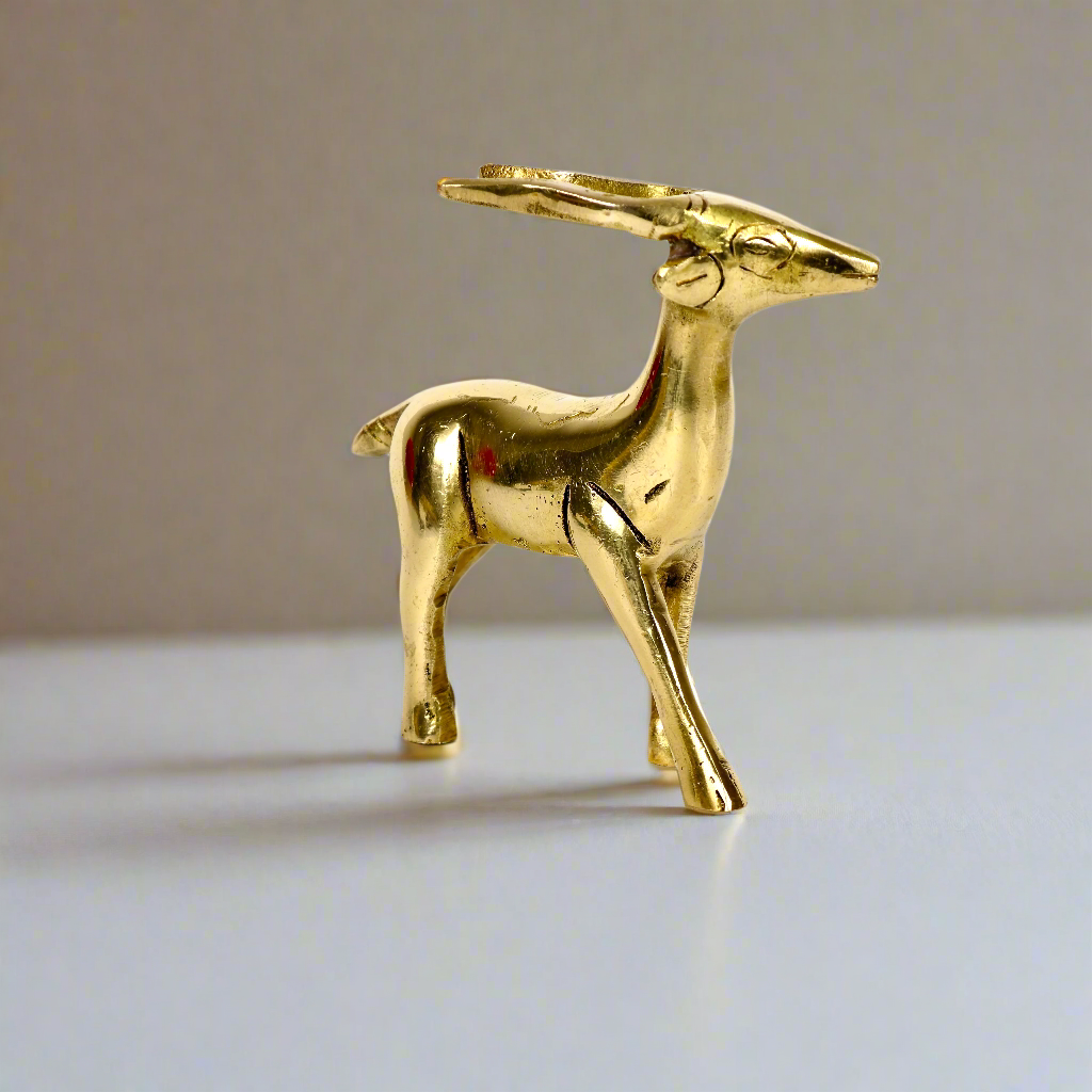 Image of a brass deer statue, elegantly designed with intricate detailing. The deer is depicted in a graceful standing posture, symbolizing peace, harmony, and gentleness. Crafted from polished brass, this statue is ideal for Vastu, home décor, or gifting to enhance positive energy and elegance in any space.