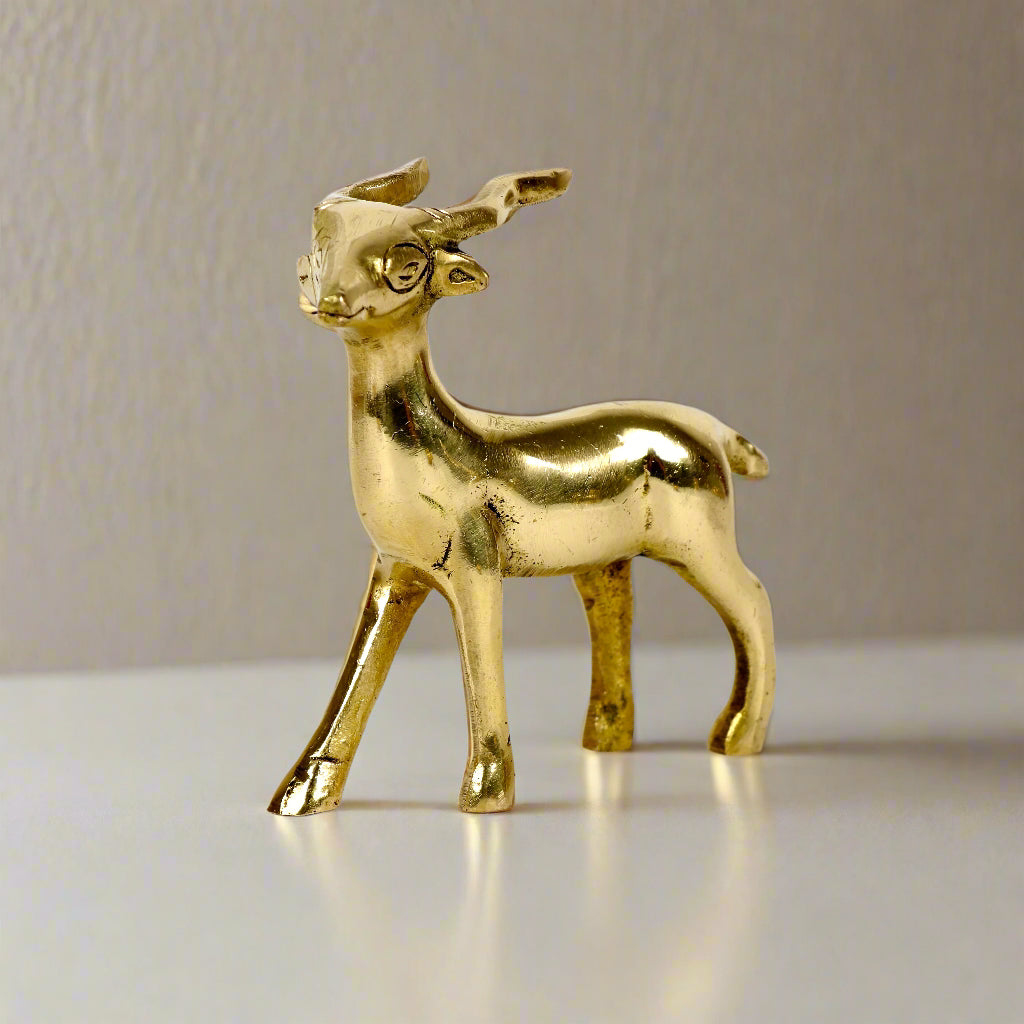 Image of a brass deer statue, elegantly designed with intricate detailing. The deer is depicted in a graceful standing posture, symbolizing peace, harmony, and gentleness. Crafted from polished brass, this statue is ideal for Vastu, home décor, or gifting to enhance positive energy and elegance in any space.