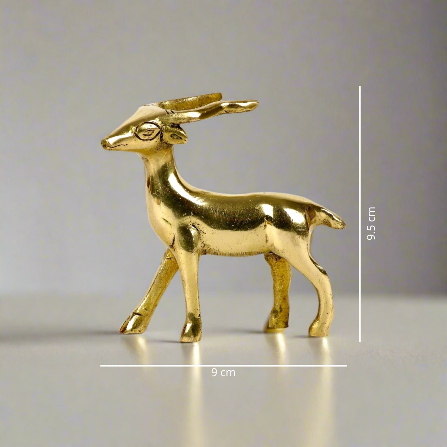 Product image of a Brass Deer figurine from Indian Impressions, featuring a graceful standing posture with intricate detailing. The polished brass finish enhances its elegance, making it perfect for Vastu, home décor, or gifting to bring harmony and positive energy to any space.