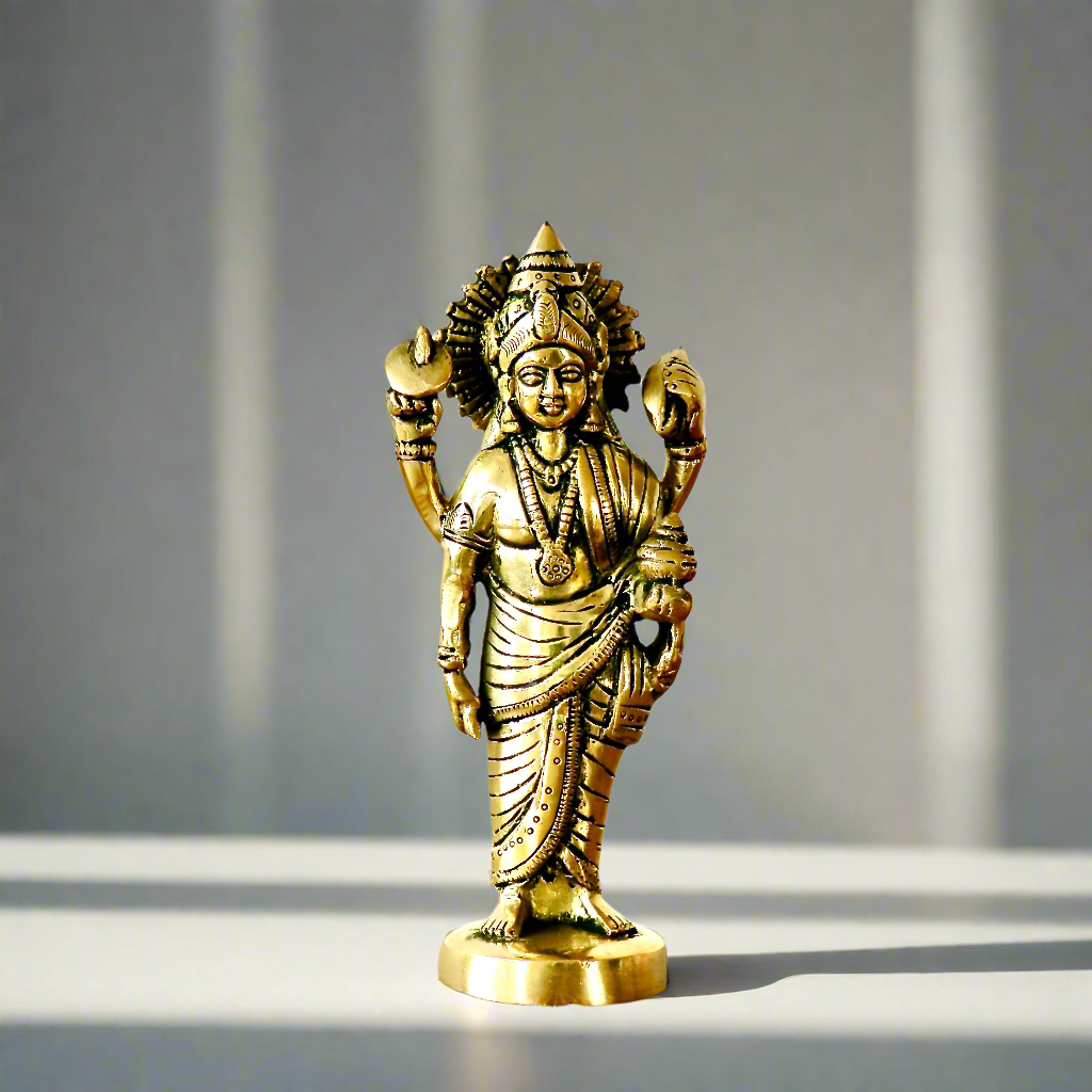 Product image of a Brass Dhanvantri Idol from Indian Impressions, showcasing Lord Dhanvantri in a standing posture holding sacred items. The idol is intricately crafted with fine details and features a polished brass finish, ideal for Vastu, spiritual practices, home décor, or gifting to promote health and well-being.