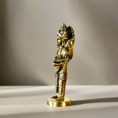 Product image of a Brass Dhanvantri Idol from Indian Impressions, showcasing Lord Dhanvantri in a standing posture holding sacred items. The idol is intricately crafted with fine details and features a polished brass finish, ideal for Vastu, spiritual practices, home décor, or gifting to promote health and well-being.