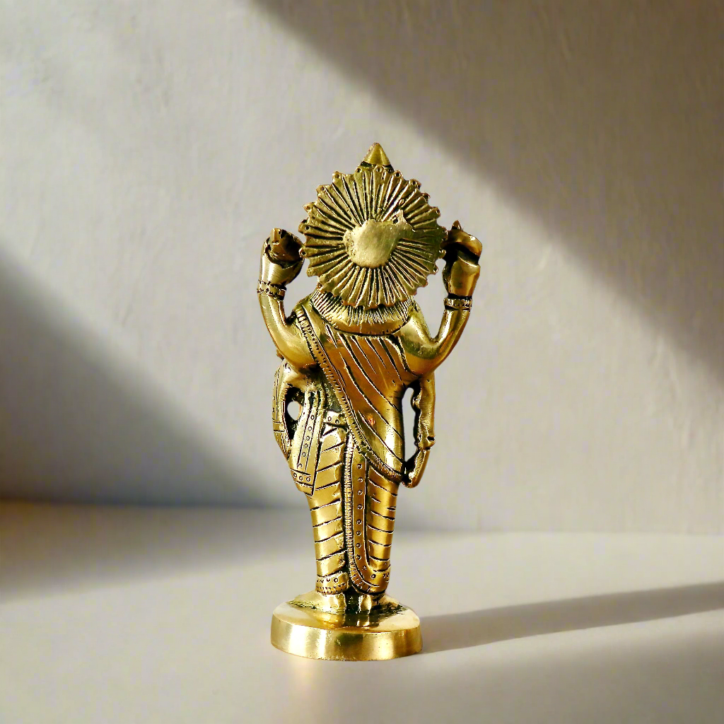 Product image of a Brass Dhanvantri Idol from Indian Impressions, showcasing Lord Dhanvantri in a standing posture holding sacred items. The idol is intricately crafted with fine details and features a polished brass finish, ideal for Vastu, spiritual practices, home décor, or gifting to promote health and well-being.