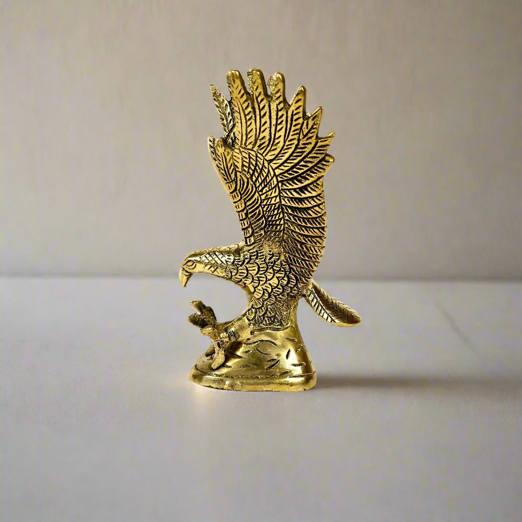 Image of a brass eagle figurine designed for Vastu purposes. The eagle is depicted in a poised stance with outspread wings, symbolizing strength, vision, and protection. Crafted from solid brass with a polished golden finish, this piece is ideal for enhancing positive energy and adding a touch of elegance to home or office spaces.