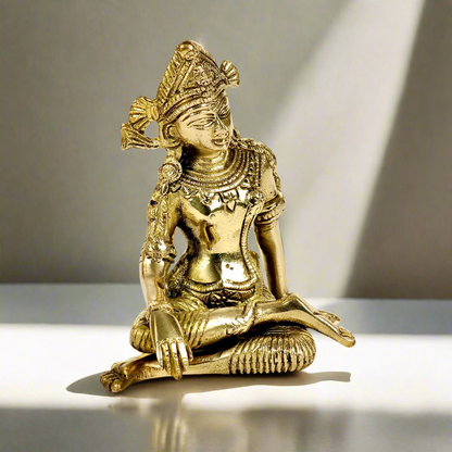 Product image of a Brass Indra Dev Idol from Indian Impressions, showcasing Lord Indra seated on his throne, holding traditional symbols. The idol is intricately crafted with fine details and a polished brass finish, making it an ideal piece for spiritual practices, home décor, or gifting to bring divine blessings and prosperity.