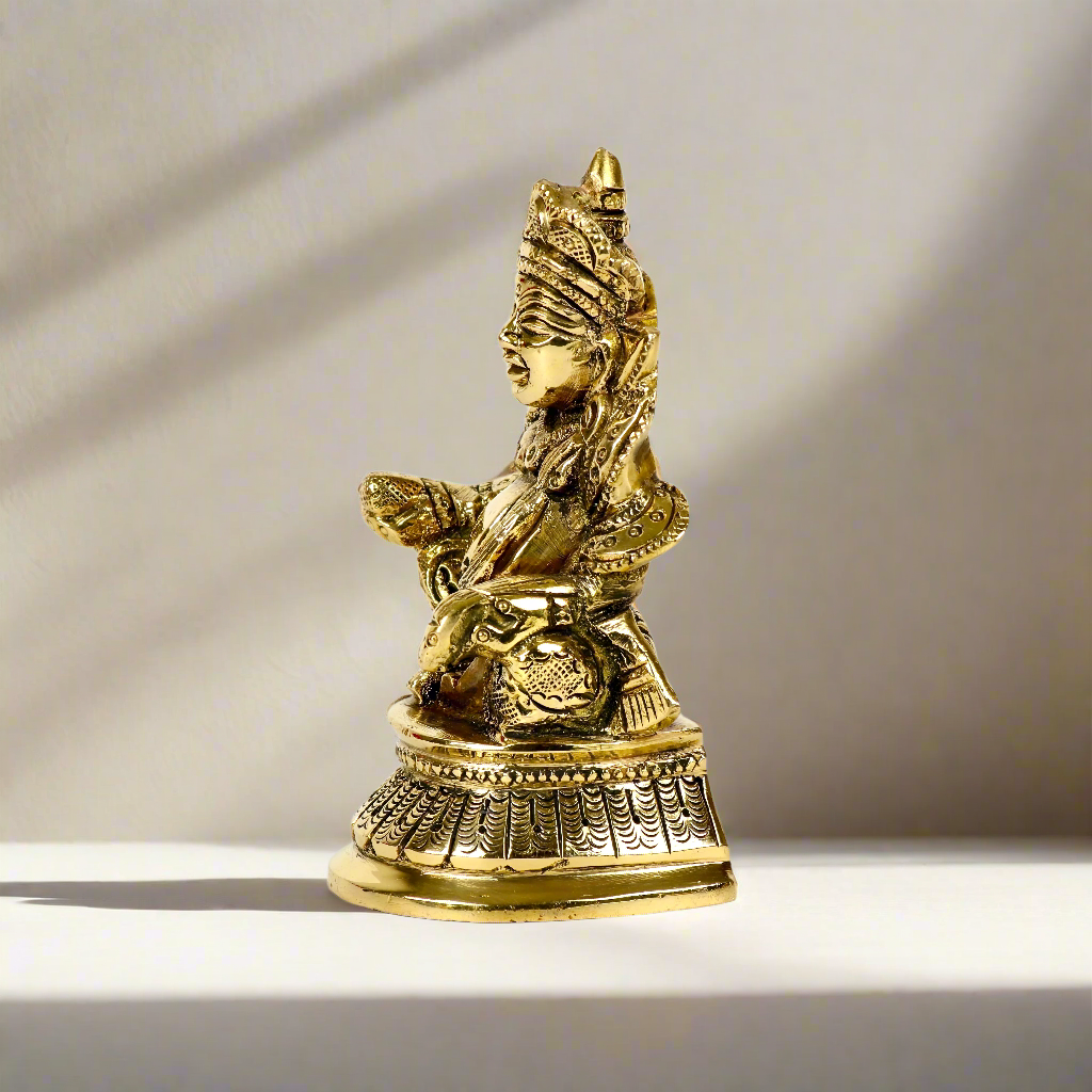 Product image of a Brass Kuber Idol from Indian Impressions, featuring Lord Kuber, the deity of wealth, seated gracefully with a pot of treasures. The idol is intricately crafted with fine details and a polished brass finish, making it perfect for Vastu, spiritual practices, home décor, or gifting to attract prosperity and abundance.