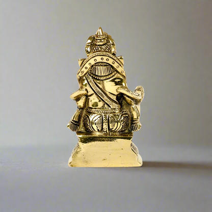 Product image of a Brass Kuber Idol from Indian Impressions, featuring Lord Kuber, the deity of wealth, seated gracefully with a pot of treasures. The idol is intricately crafted with fine details and a polished brass finish, making it perfect for Vastu, spiritual practices, home décor, or gifting to attract prosperity and abundance.