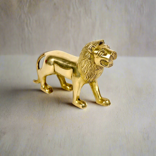 Product image of a Brass Lion figurine from Indian Impressions, showcasing a majestic lion in a poised stance with intricate detailing. Symbolizing strength, courage, and protection, the polished brass finish enhances its regal appeal. Perfect for Vastu, home décor, or gifting to bring power and positive energy to any space.