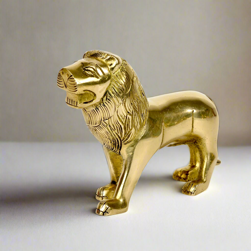 Product image of a Brass Lion figurine from Indian Impressions, showcasing a majestic lion in a poised stance with intricate detailing. Symbolizing strength, courage, and protection, the polished brass finish enhances its regal appeal. Perfect for Vastu, home décor, or gifting to bring power and positive energy to any space.