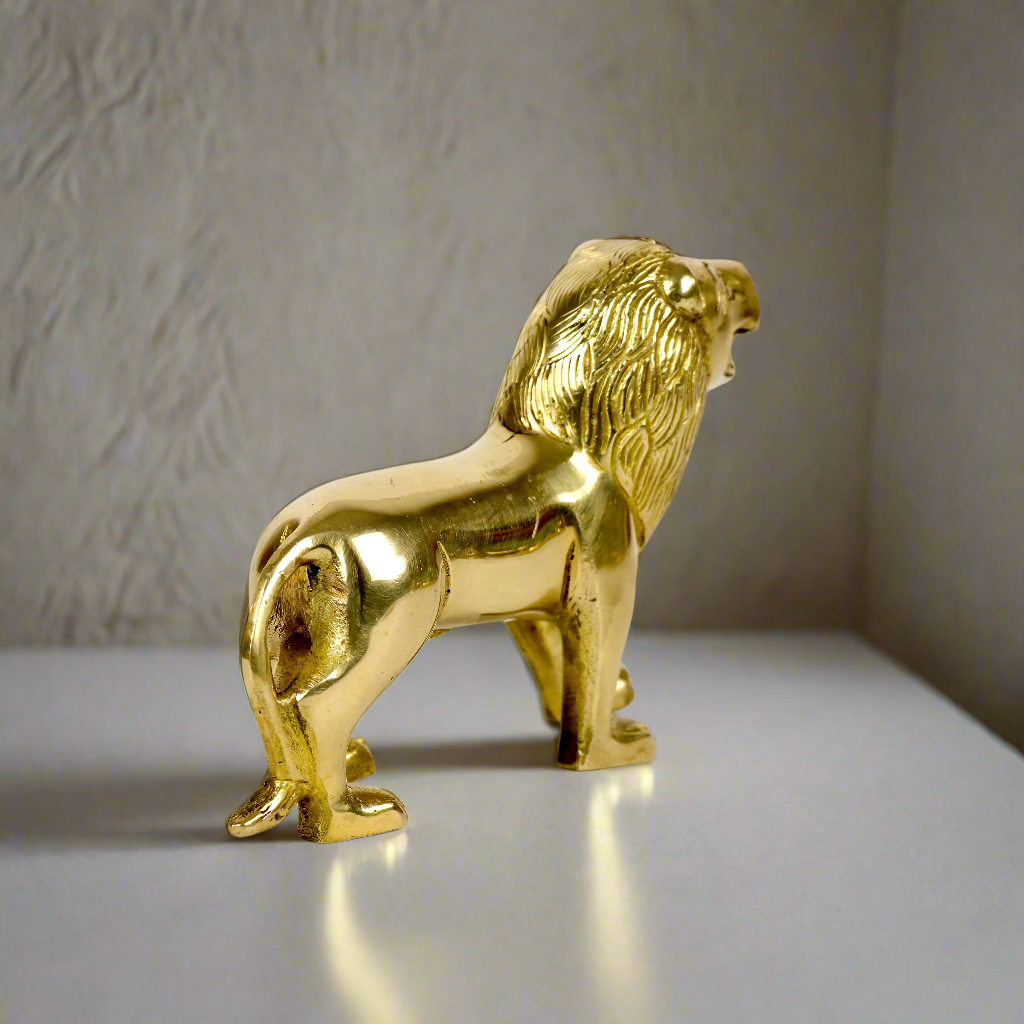 Product image of a Brass Lion figurine from Indian Impressions, showcasing a majestic lion in a poised stance with intricate detailing. Symbolizing strength, courage, and protection, the polished brass finish enhances its regal appeal. Perfect for Vastu, home décor, or gifting to bring power and positive energy to any space.