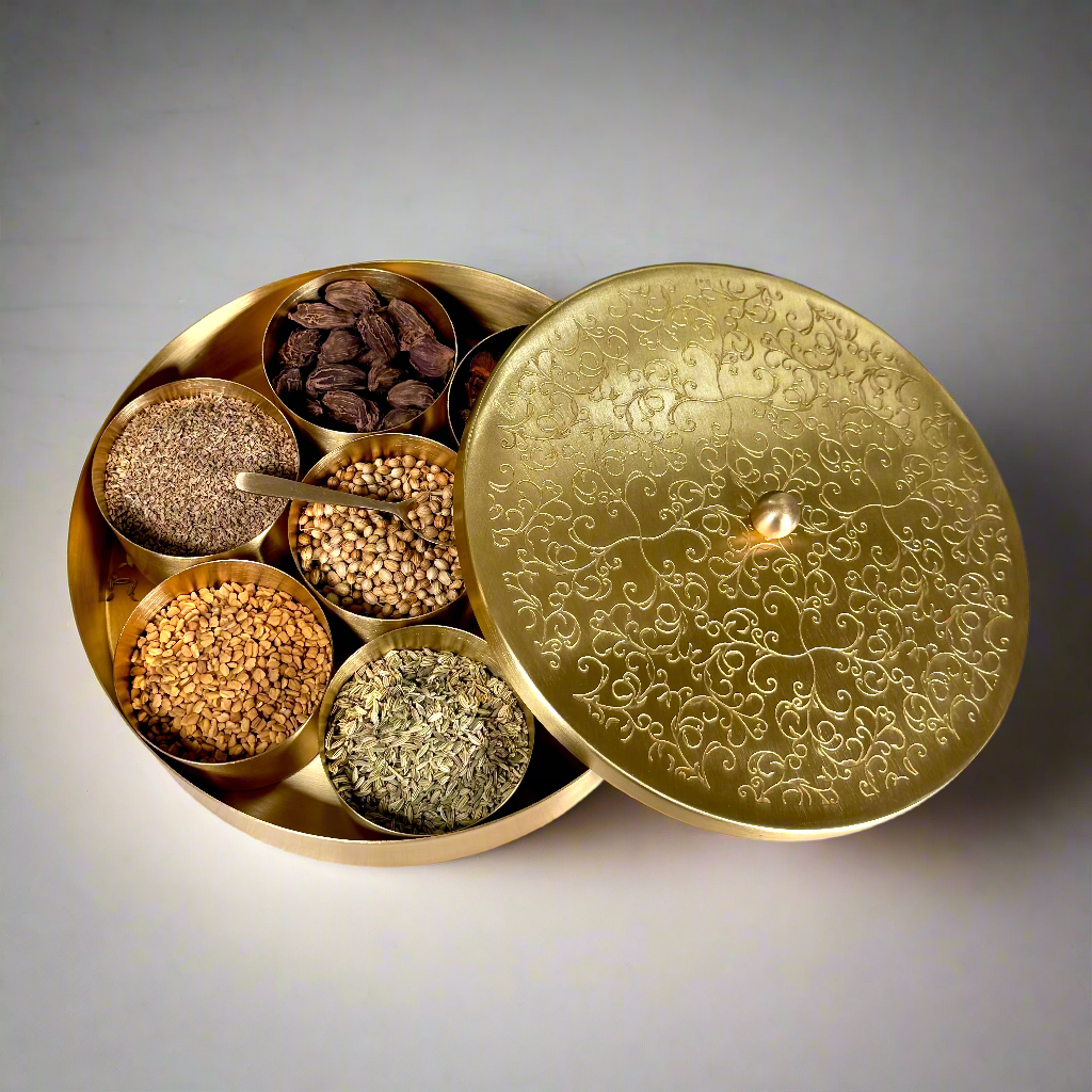 Product image of a Brass Spice Box from Indian Impressions, featuring a traditional round design with multiple compartments for storing spices. Crafted from polished brass with intricate detailing, this spice box is both functional and decorative, ideal for enhancing Vastu energy, kitchen aesthetics, or gifting.