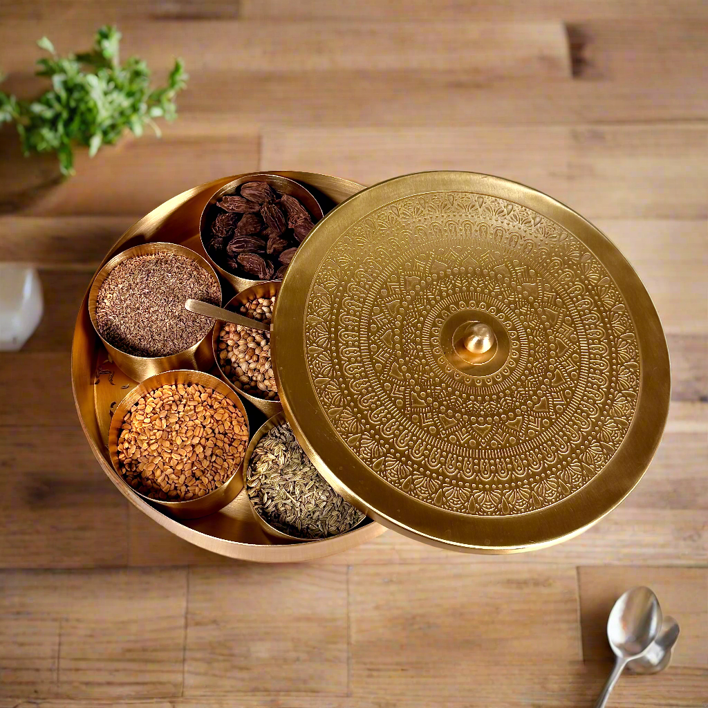 Product image of a Brass Spice Box from Indian Impressions, featuring a traditional round design with multiple compartments for storing spices. Crafted from polished brass with intricate detailing, this spice box is both functional and decorative, ideal for enhancing Vastu energy, kitchen aesthetics, or gifting.