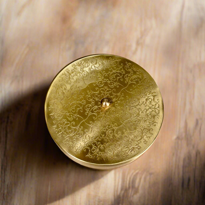 Product image of a Brass Spice Box from Indian Impressions, featuring a traditional round design with multiple compartments for storing spices. Crafted from polished brass with intricate detailing, this spice box is both functional and decorative, ideal for enhancing Vastu energy, kitchen aesthetics, or gifting.