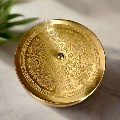 Product image of a Brass Spice Box from Indian Impressions, featuring a traditional round design with multiple compartments for storing spices. Crafted from polished brass with intricate detailing, this spice box is both functional and decorative, ideal for enhancing Vastu energy, kitchen aesthetics, or gifting.