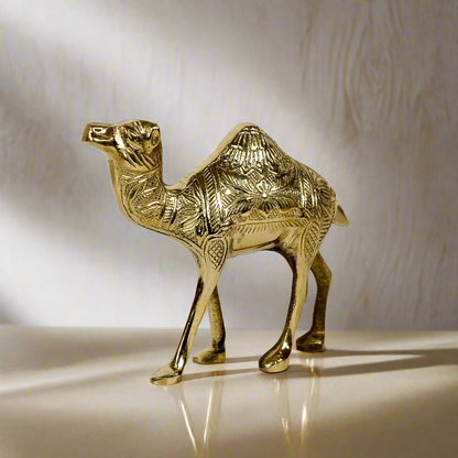 Product image of a Brass Camel figurine from Indian Impressions, intricately crafted with detailed features. The camel is depicted in a standing posture, symbolizing endurance and strength. Finished with a polished brass shine, this decorative piece is ideal for Vastu, home décor, or gifting.