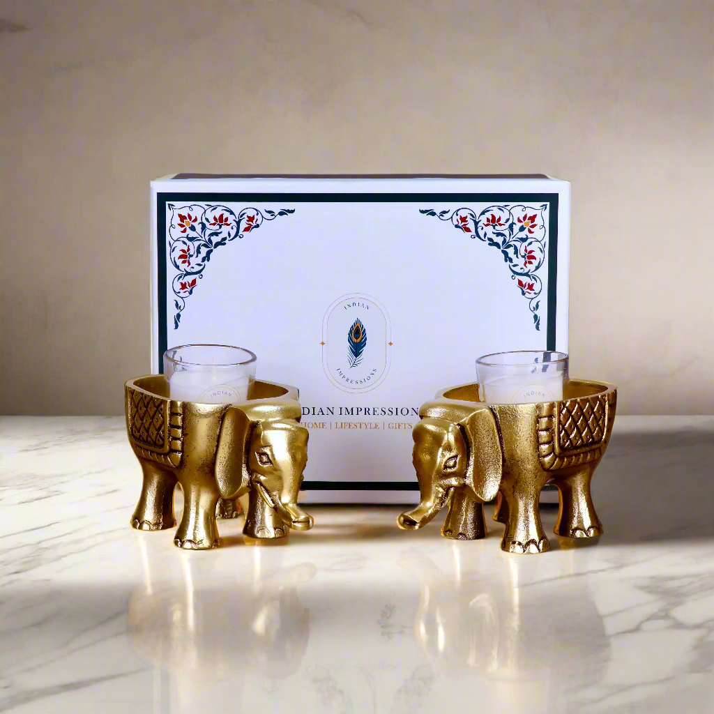 Product image of an Elephant Antique Brass Finish figurine from Indian Impressions, intricately crafted with detailed features. The elephant, symbolizing strength, wisdom, and good luck, is finished in a rich antique brass tone. The figurine comes with a gift box, making it an ideal gift for home décor, spiritual practices, or Vastu.