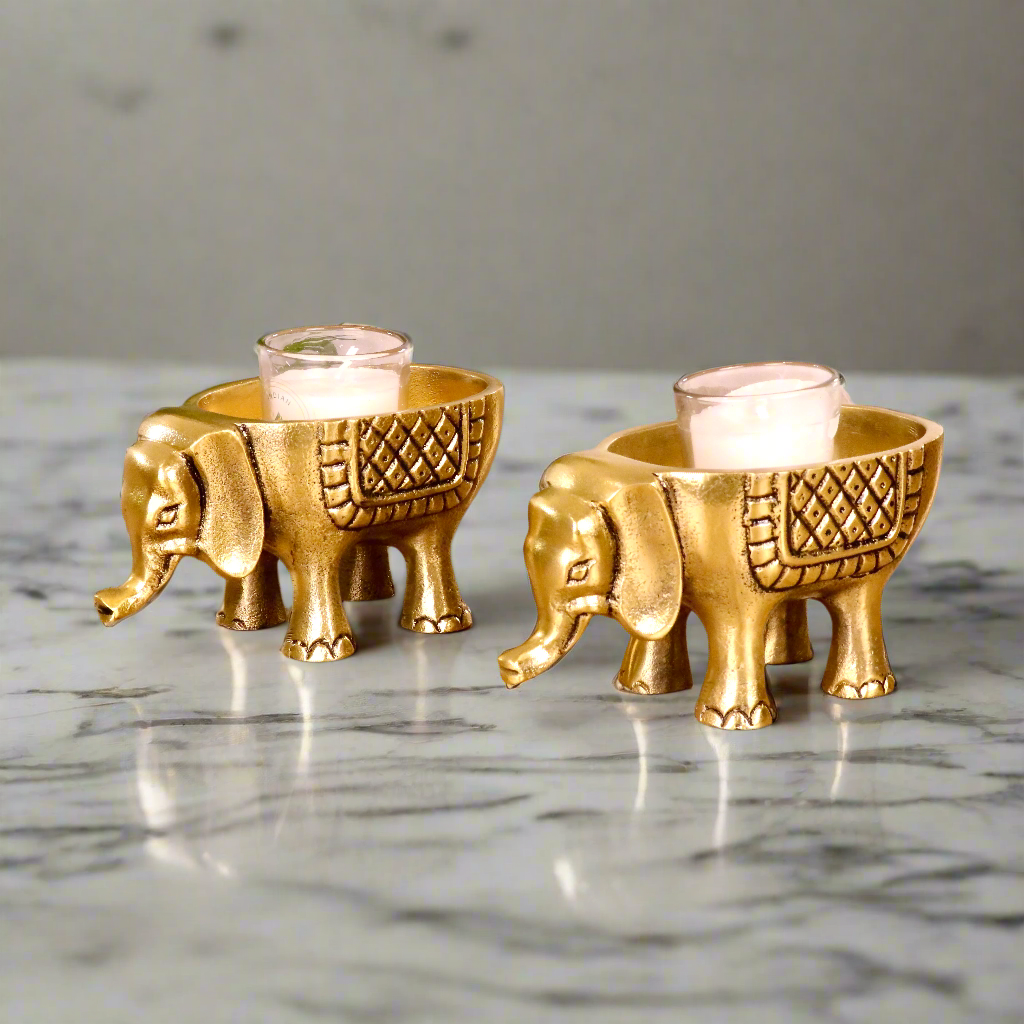 Product image of an Elephant Antique Brass Finish figurine from Indian Impressions, intricately crafted with detailed features. The elephant, symbolizing strength, wisdom, and good luck, is finished in a rich antique brass tone. The figurine comes with a gift box, making it an ideal gift for home décor, spiritual practices, or Vastu.