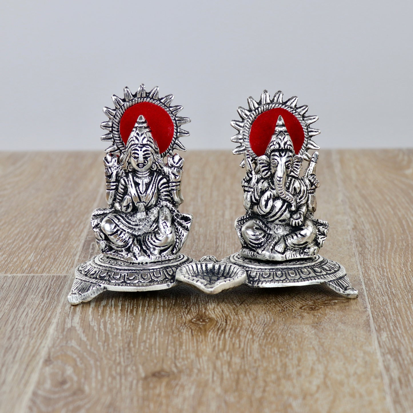 Product image of a Ganesh Lakshmi Gift Set in Silver from Indian Impressions, featuring intricately crafted idols of Lord Ganesha and Goddess Lakshmi. The idols are made with a polished silver finish, symbolizing prosperity, wisdom, and blessings. Ideal for gifting, home décor, or spiritual practices, this set brings divine energy and elegance to any space.