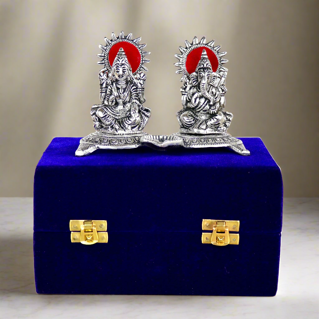 Product image of a Ganesh Lakshmi Gift Set in Silver from Indian Impressions, featuring intricately crafted idols of Lord Ganesha and Goddess Lakshmi. The idols are made with a polished silver finish, symbolizing prosperity, wisdom, and blessings. Ideal for gifting, home décor, or spiritual practices, this set brings divine energy and elegance to any space.