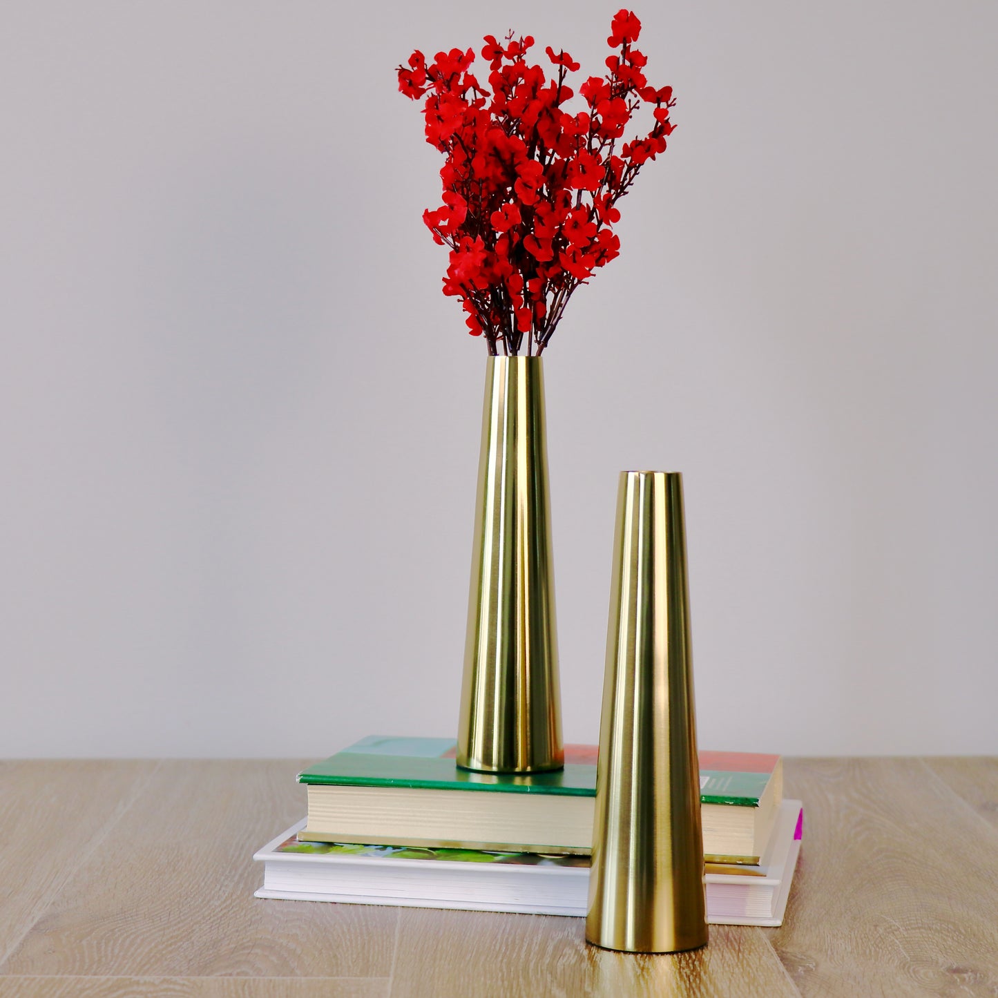 Product image of a Gold Slim Cone Vase Set of 2 from Indian Impressions, featuring sleek, modern designs with a polished gold finish. These vases are ideal for displaying flowers or as standalone decorative pieces. Perfect for enhancing Vastu energy, home décor, or gifting, adding elegance and sophistication to any space.