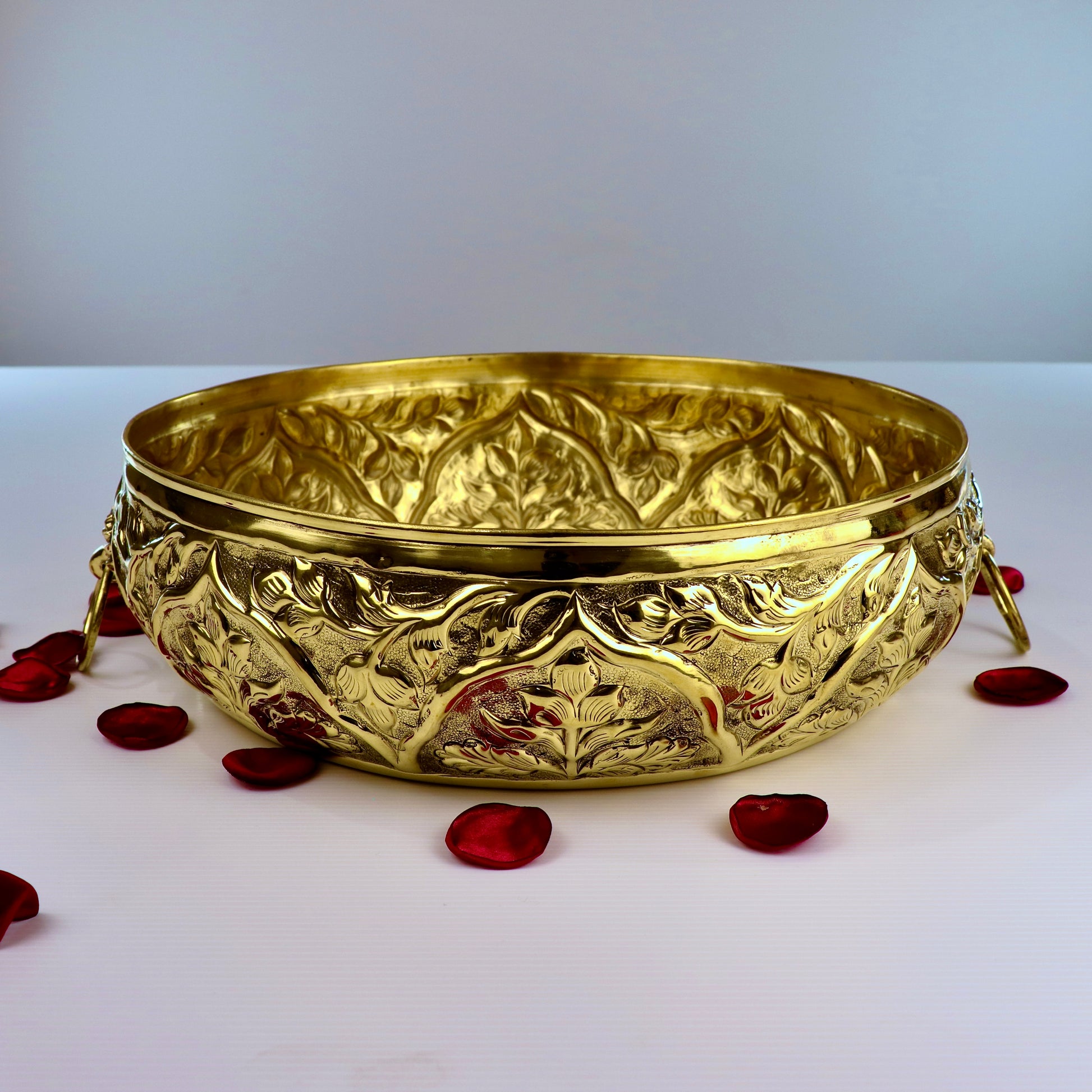 Product image of a Brass Gulmohar Urli from Indian Impressions, featuring a beautifully crafted design with intricate floral detailing. The urli has a polished brass finish, ideal for adding a touch of elegance to home décor, spiritual rituals, or gifting, and is perfect for enhancing the ambiance of any space.