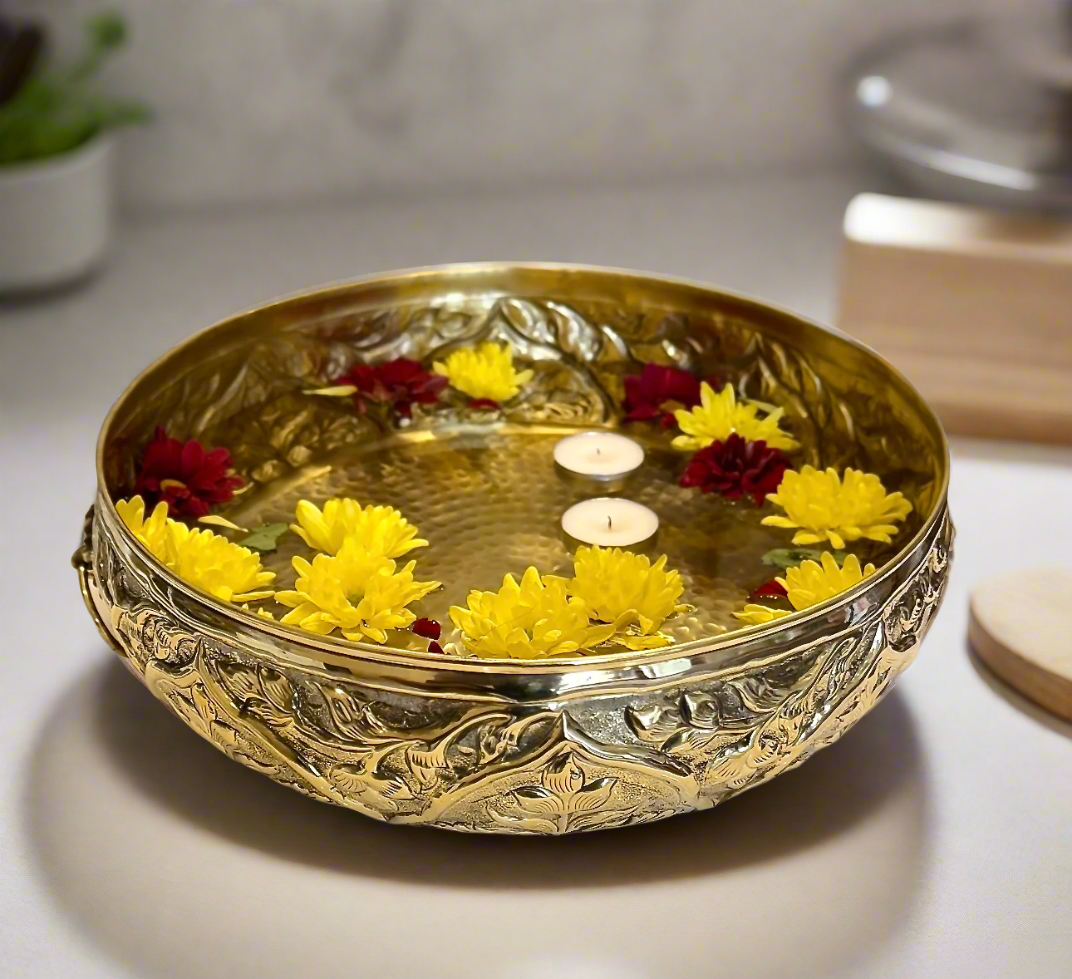 Product image of a Brass Gulmohar Urli from Indian Impressions, featuring a beautifully crafted design with intricate floral detailing. The urli has a polished brass finish, ideal for adding a touch of elegance to home décor, spiritual rituals, or gifting, and is perfect for enhancing the ambiance of any space.