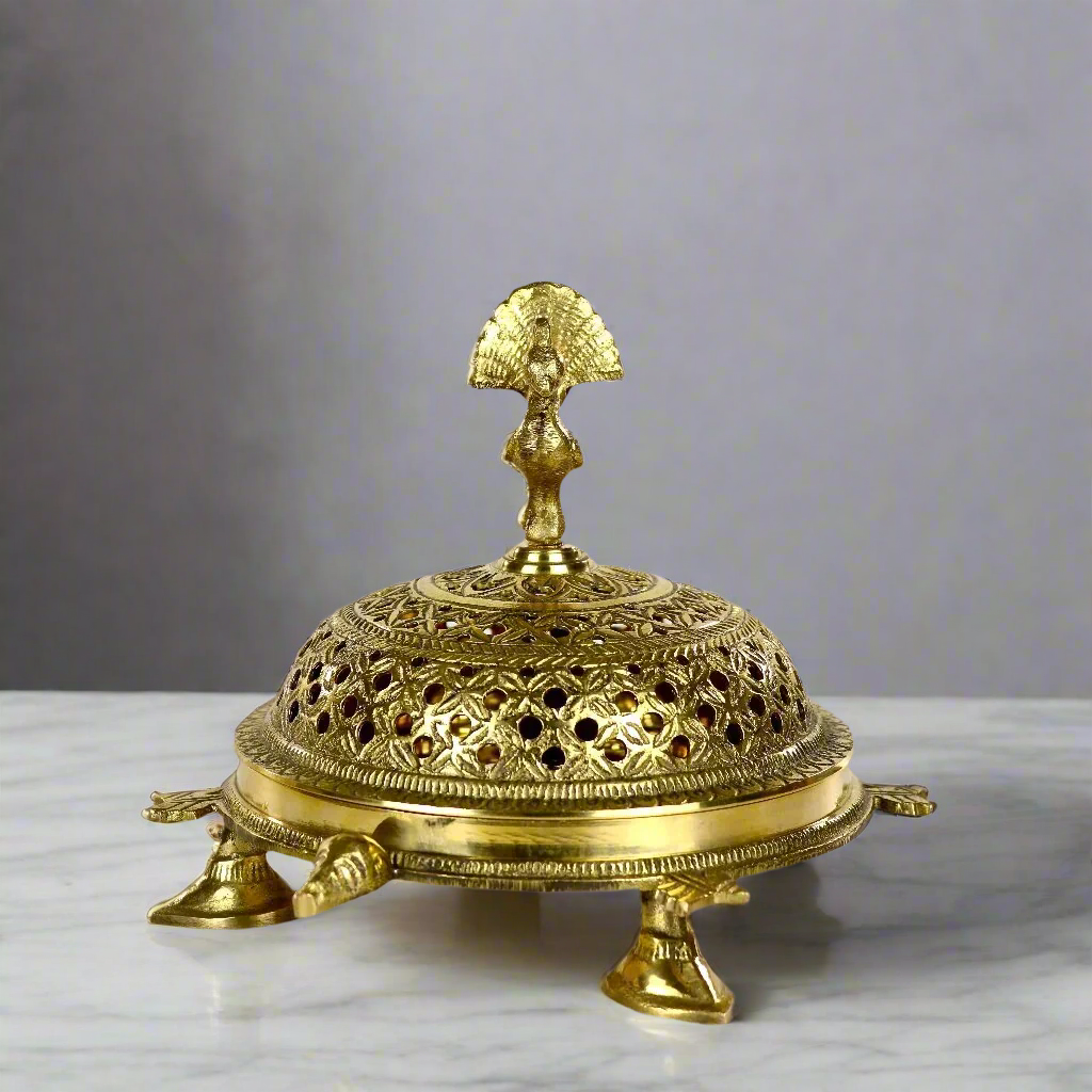 Product image of a Brass Mayur Dhuna from Indian Impressions, showcasing an intricately designed peacock-shaped incense holder. Crafted from polished brass with fine detailing, this dhuna is perfect for Vastu, spiritual rituals, home décor, or gifting, symbolizing grace, positivity, and divine energy.