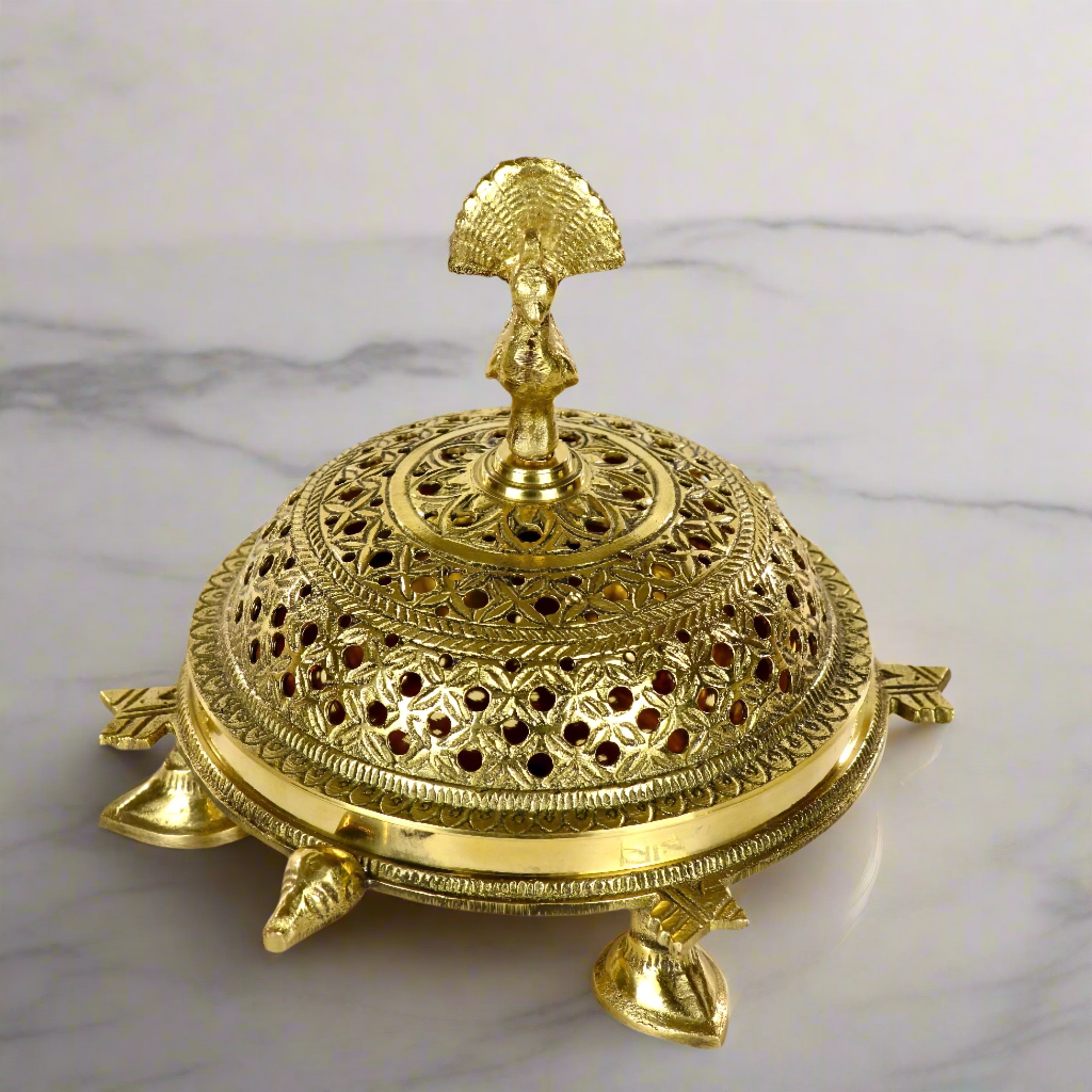 Product image of a Brass Mayur Dhuna from Indian Impressions, showcasing an intricately designed peacock-shaped incense holder. Crafted from polished brass with fine detailing, this dhuna is perfect for Vastu, spiritual rituals, home décor, or gifting, symbolizing grace, positivity, and divine energy.