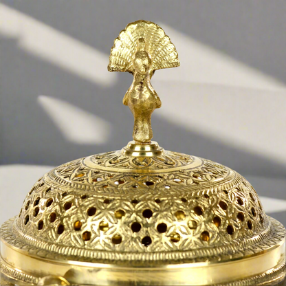 Product image of a Brass Mayur Dhuna from Indian Impressions, showcasing an intricately designed peacock-shaped incense holder. Crafted from polished brass with fine detailing, this dhuna is perfect for Vastu, spiritual rituals, home décor, or gifting, symbolizing grace, positivity, and divine energy.