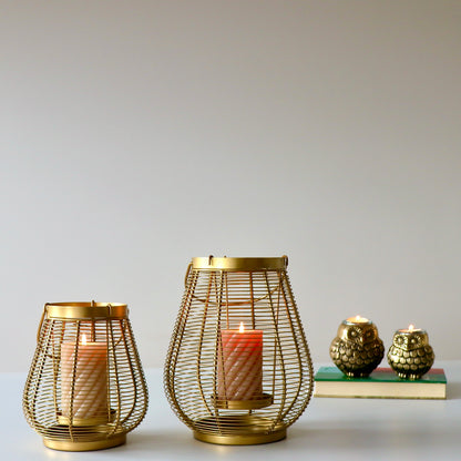 Product image of a Metal Cage Lantern from Indian Impressions, featuring a sleek, openwork cage design with a polished finish. This lantern is ideal for holding candles or LED lights, adding a warm and elegant ambiance to any space. Perfect for Vastu, home décor, or gifting.