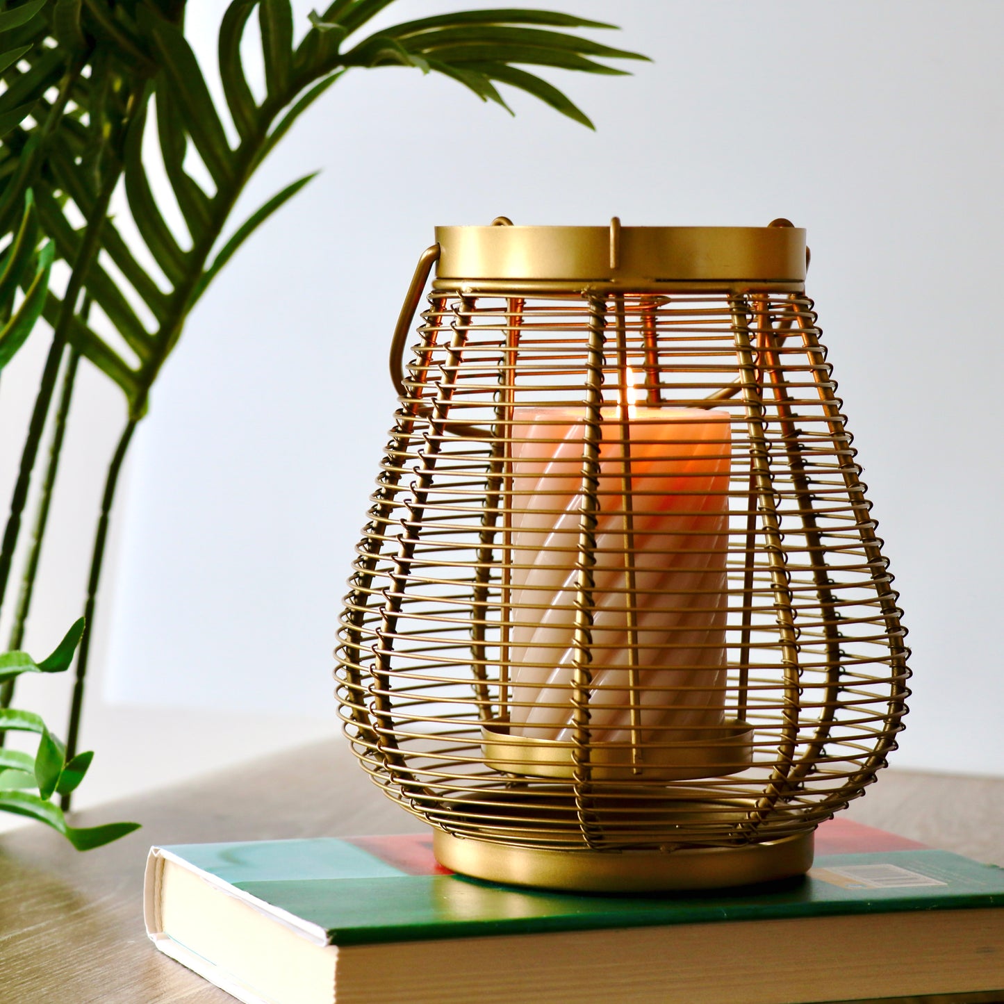 Product image of a Metal Cage Lantern from Indian Impressions, featuring a sleek, openwork cage design with a polished finish. This lantern is ideal for holding candles or LED lights, adding a warm and elegant ambiance to any space. Perfect for Vastu, home décor, or gifting.