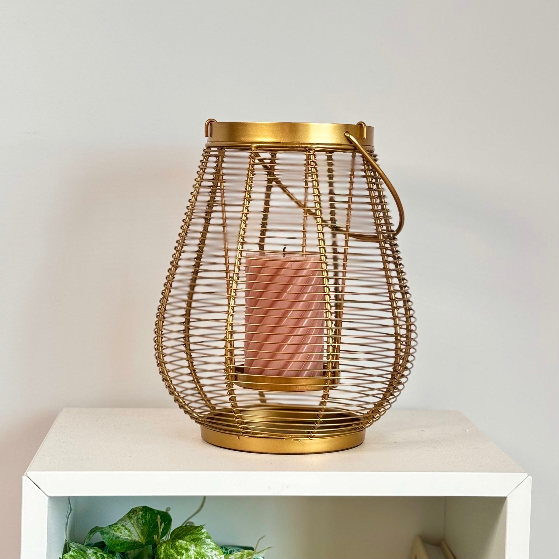 Product image of a Metal Cage Lantern from Indian Impressions, featuring a sleek, openwork cage design with a polished finish. This lantern is ideal for holding candles or LED lights, adding a warm and elegant ambiance to any space. Perfect for Vastu, home décor, or gifting.