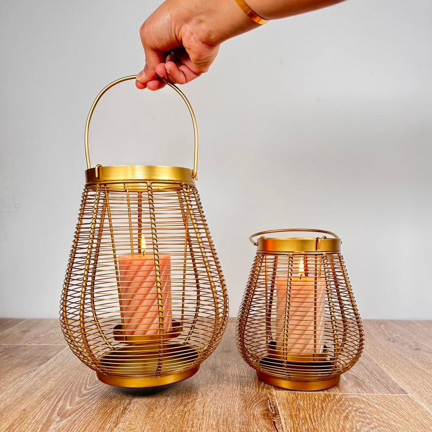 Product image of a Metal Cage Lantern from Indian Impressions, featuring a sleek, openwork cage design with a polished finish. This lantern is ideal for holding candles or LED lights, adding a warm and elegant ambiance to any space. Perfect for Vastu, home décor, or gifting.