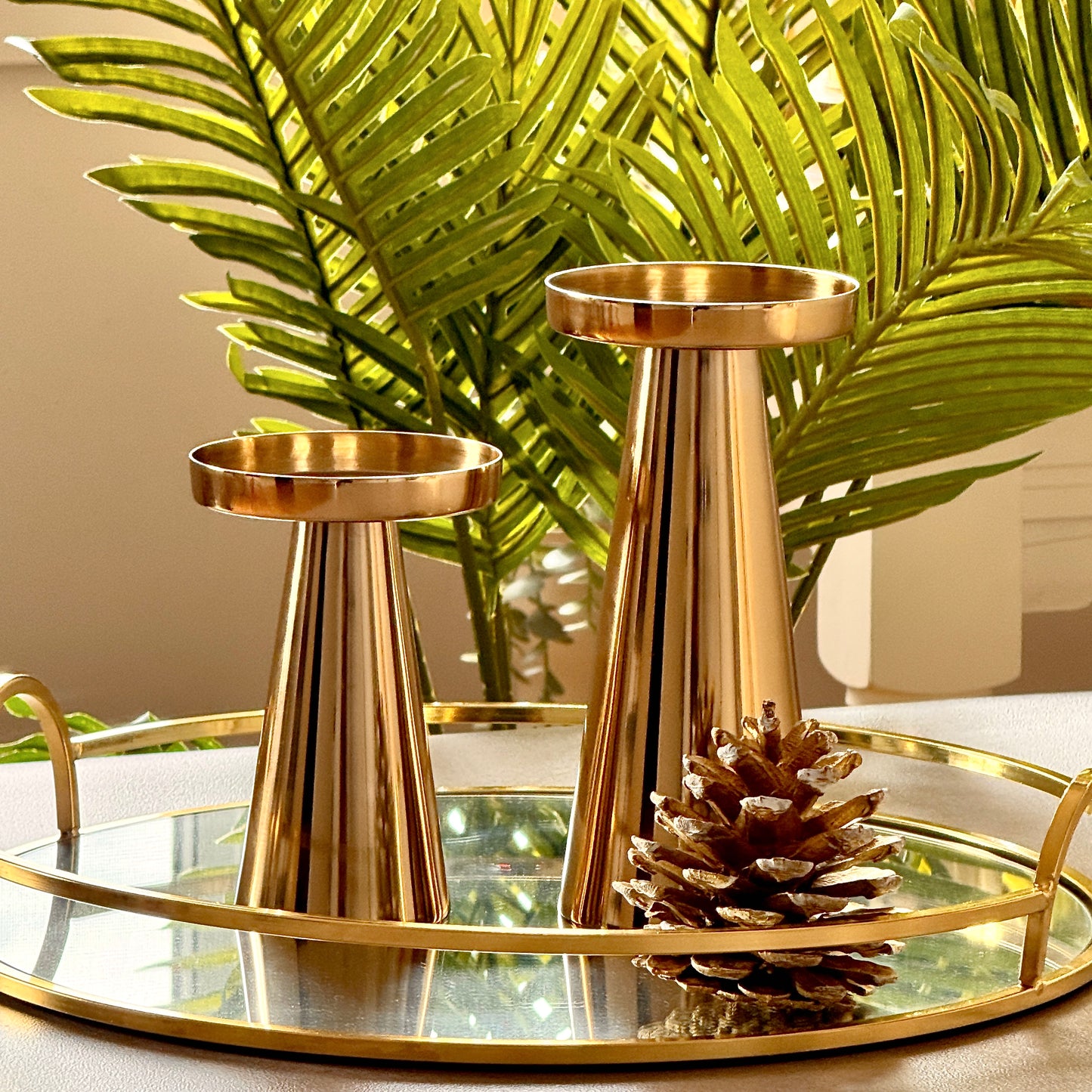 Product image of a Metal Candle Holder Set of 2 from Indian Impressions, featuring elegantly crafted holders with a polished finish. Designed for pillar or taper candles, these holders add a touch of sophistication to any setting. Perfect for Vastu, home décor, festive occasions, or gifting.