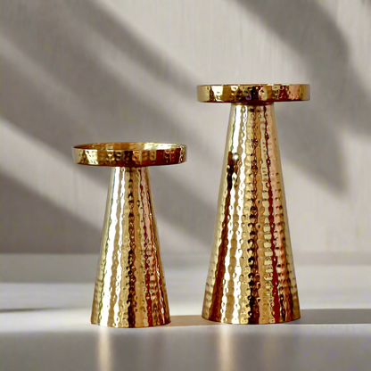 Product image of a Metal Candle Holder Set of 2 from Indian Impressions, featuring elegantly crafted holders with a Hammered finish. Designed for pillar or taper candles, these holders add a touch of sophistication to any setting. Perfect for Vastu, home décor, festive occasions, or gifting.