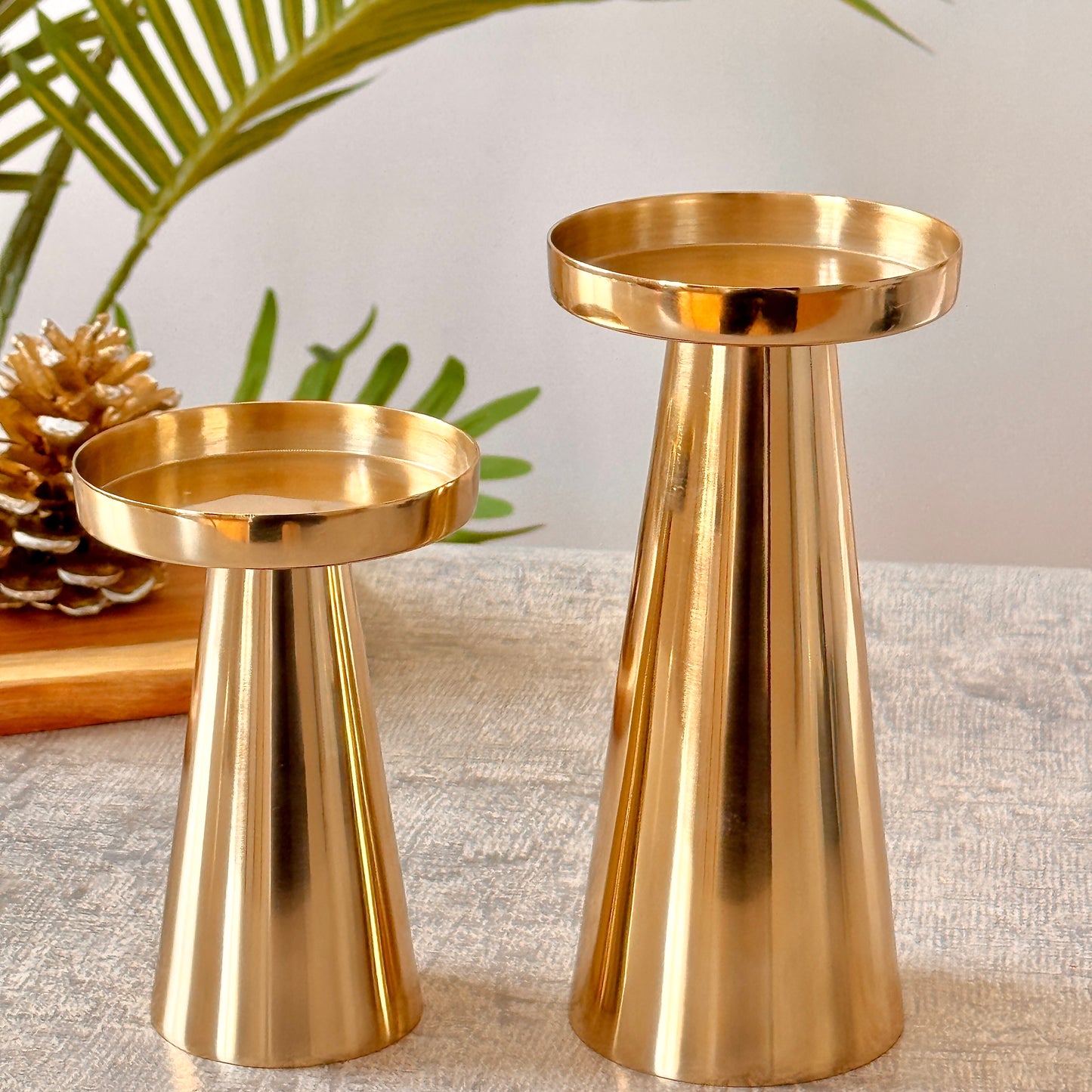 Product image of a Metal Candle Holder Set of 2 from Indian Impressions, featuring elegantly crafted holders with a polished finish. Designed for pillar or taper candles, these holders add a touch of sophistication to any setting. Perfect for Vastu, home décor, festive occasions, or gifting.