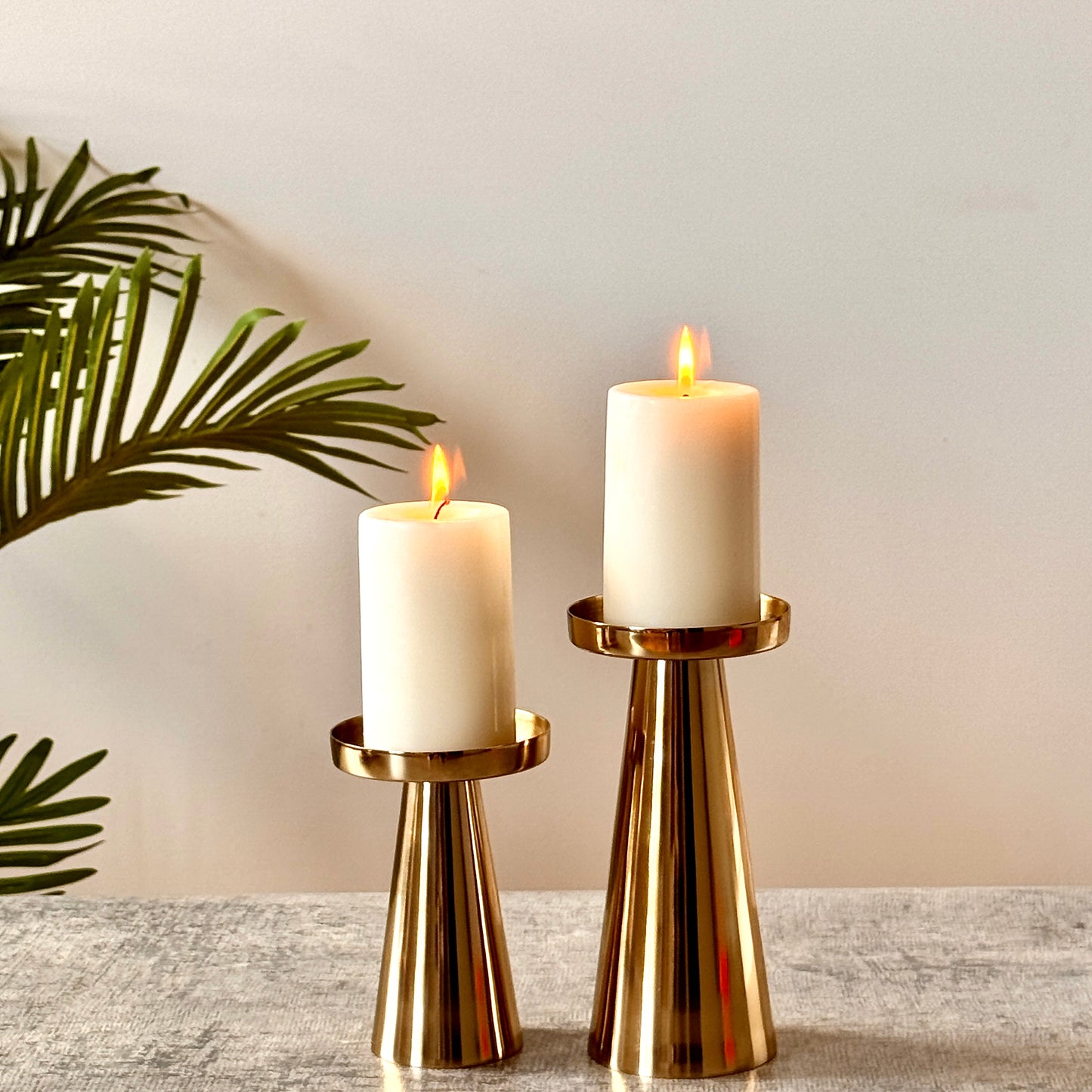 Product image of a Metal Candle Holder Set of 2 from Indian Impressions, featuring elegantly crafted holders with a polished finish. Designed for pillar or taper candles, these holders add a touch of sophistication to any setting. Perfect for Vastu, home décor, festive occasions, or gifting.