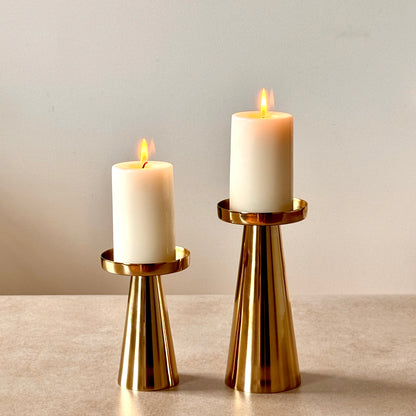 Product image of a Metal Candle Holder Set of 2 from Indian Impressions, featuring elegantly crafted holders with a polished finish. Designed for pillar or taper candles, these holders add a touch of sophistication to any setting. Perfect for Vastu, home décor, festive occasions, or gifting.