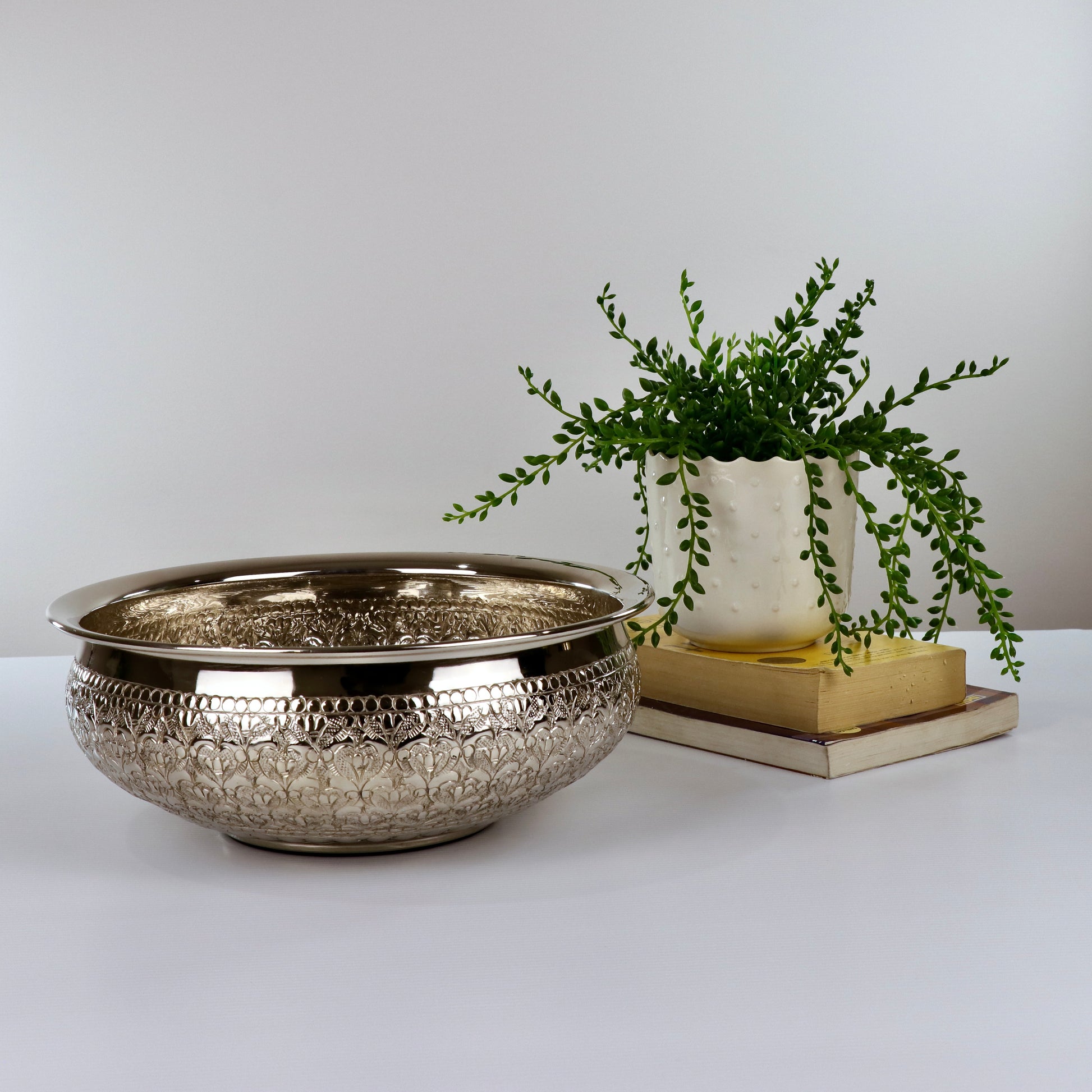 Product image of the Modini Chitai Urli Silver from Indian Impressions, showcasing an intricately handcrafted design with detailed patterns. Made with a polished silver-tone finish, this urli is perfect for Vastu, home décor, festive decorations, or gifting, bringing elegance and positive energy to any space.