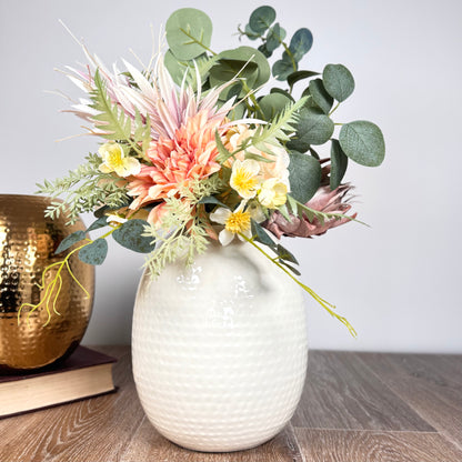 Product image of the Oval Vase Hammered White from Indian Impressions, featuring a sleek oval shape with a textured hammered finish. Designed with a polished white tone, this vase is ideal for displaying flowers or as a standalone décor piece. Perfect for Vastu, home décor, or gifting, bringing a modern and elegant touch to any space.