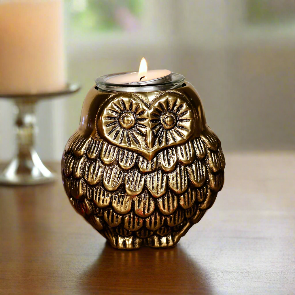 Product image of the Owl Figurine Pair Tea light Holder with Antique Brass Finish from Indian Impressions, featuring two intricately designed owl statues with detailed craftsmanship. Symbolizing wisdom and protection, these figurines are ideal for Vastu, home décor, or gifting, adding a touch of charm and positive energy to any space.