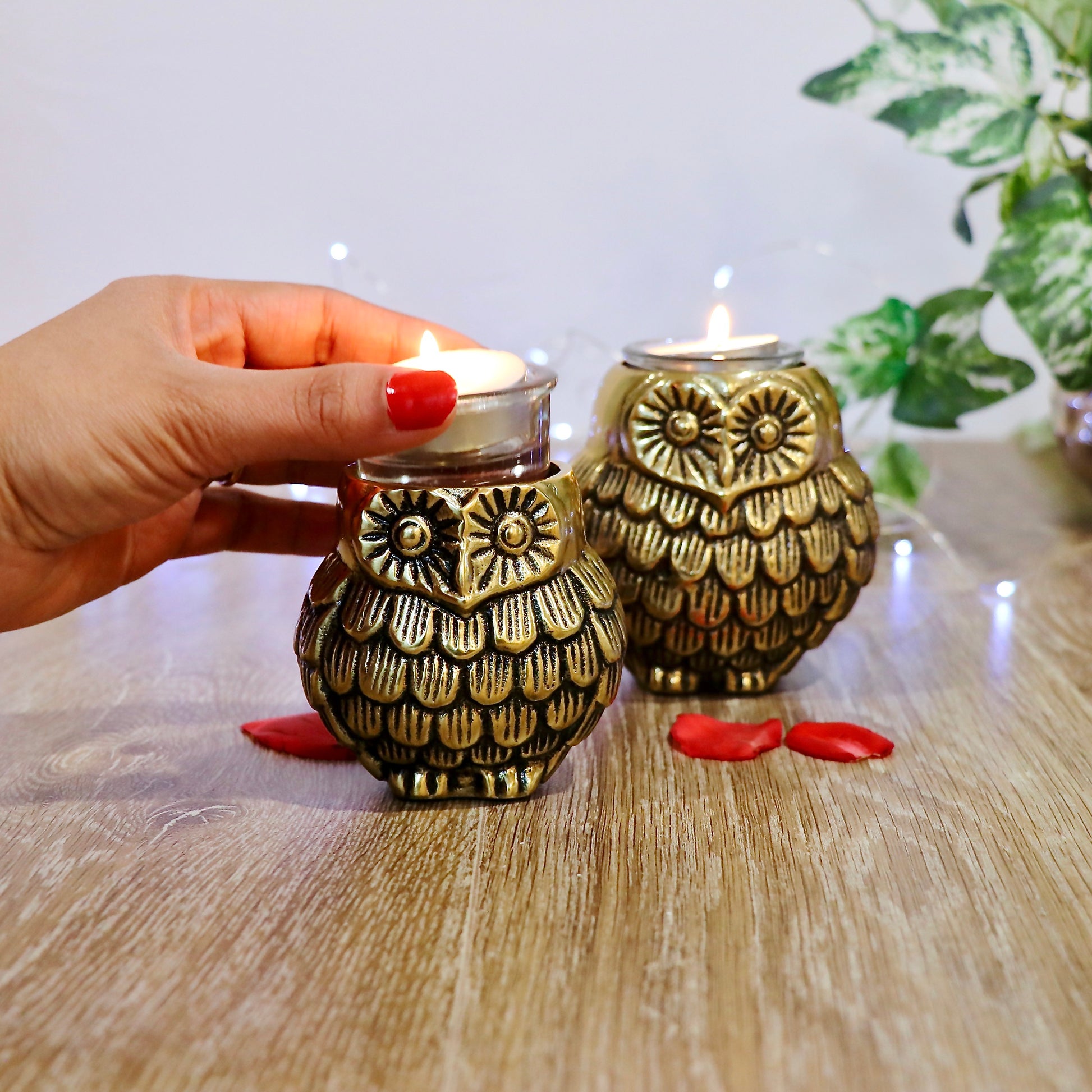 Product image of the Owl Figurine Pair Tea light Holder with Antique Brass Finish from Indian Impressions, featuring two intricately designed owl statues with detailed craftsmanship. Symbolizing wisdom and protection, these figurines are ideal for Vastu, home décor, or gifting, adding a touch of charm and positive energy to any space.