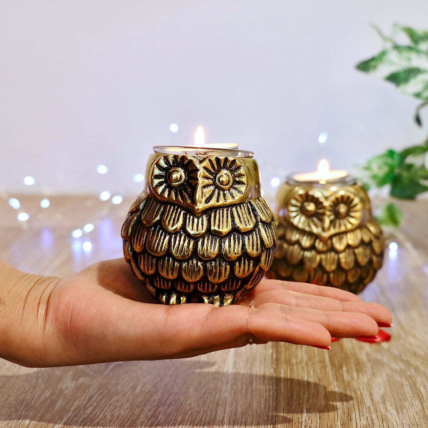 Product image of the Owl Figurine Pair Tea light Holder with Antique Brass Finish from Indian Impressions, featuring two intricately designed owl statues with detailed craftsmanship. Symbolizing wisdom and protection, these figurines are ideal for Vastu, home décor, or gifting, adding a touch of charm and positive energy to any space.