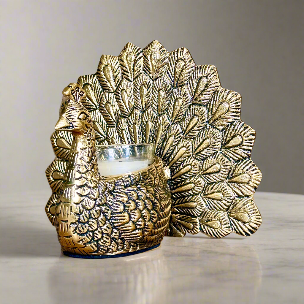 Product image of the Peacock Candle Holder with Antique Brass Finish from Indian Impressions, showcasing a stunning peacock design with intricate detailing and a vintage-inspired finish. Ideal for holding candles, this piece is perfect for Vastu, home décor, festive occasions, or gifting, adding elegance and positive energy to any space.