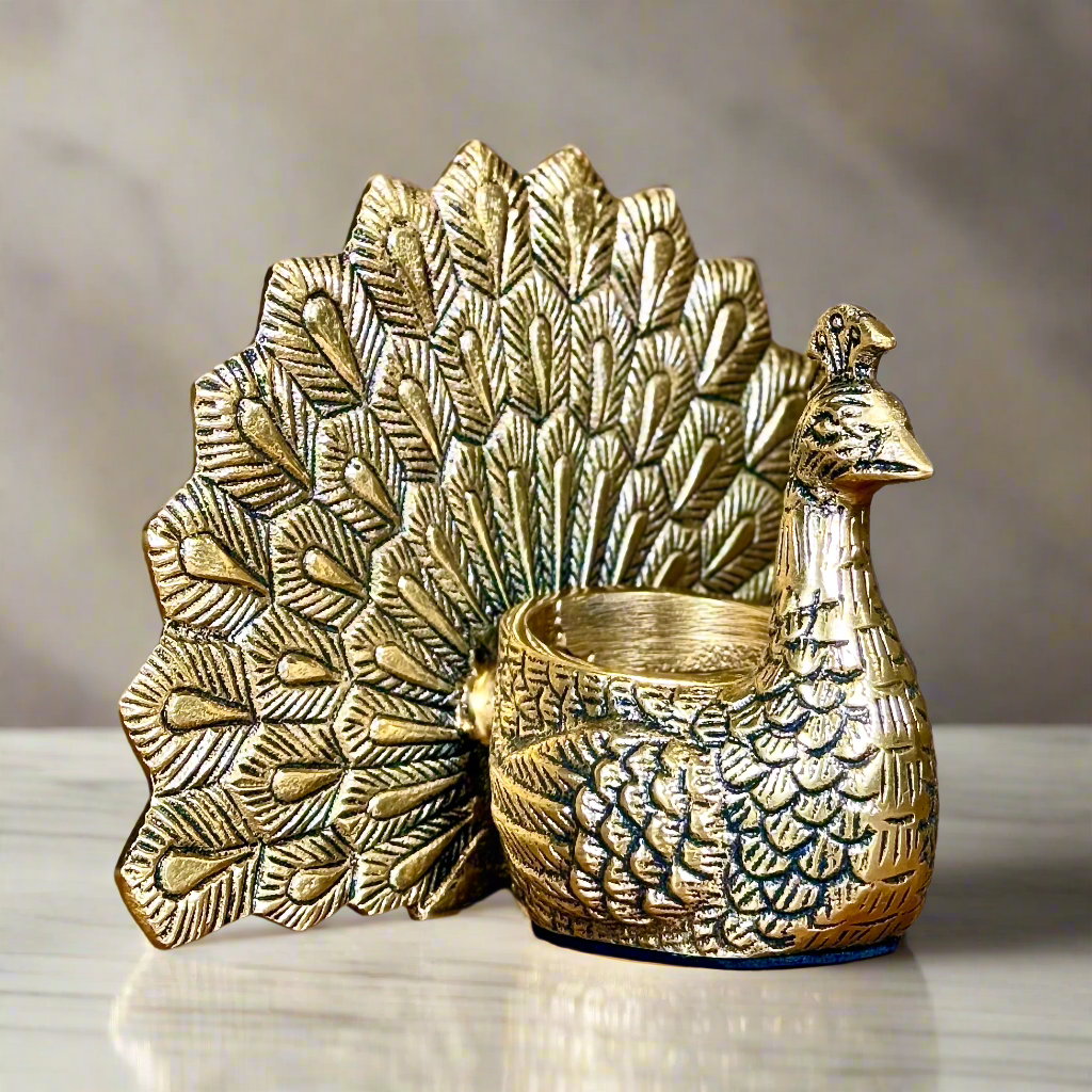 Product image of the Peacock Candle Holder with Antique Brass Finish from Indian Impressions, showcasing a stunning peacock design with intricate detailing and a vintage-inspired finish. Ideal for holding candles, this piece is perfect for Vastu, home décor, festive occasions, or gifting, adding elegance and positive energy to any space.