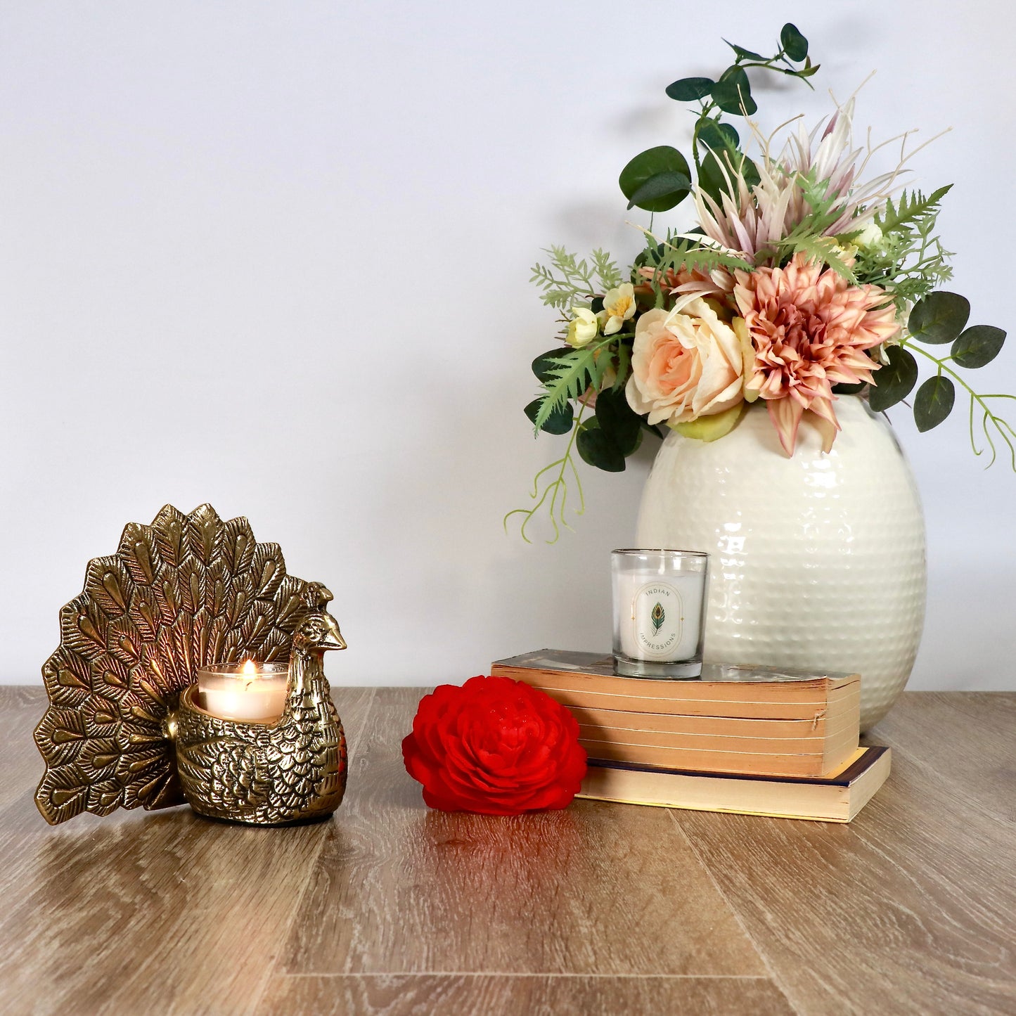 Product image of the Peacock Candle Holder with Antique Brass Finish from Indian Impressions, showcasing a stunning peacock design with intricate detailing and a vintage-inspired finish. Ideal for holding candles, this piece is perfect for Vastu, home décor, festive occasions, or gifting, adding elegance and positive energy to any space.