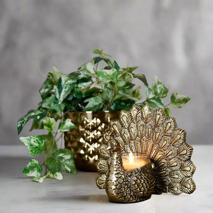 Product image of the Peacock Candle Holder with Antique Brass Finish from Indian Impressions, showcasing a stunning peacock design with intricate detailing and a vintage-inspired finish. Ideal for holding candles, this piece is perfect for Vastu, home décor, festive occasions, or gifting, adding elegance and positive energy to any space.